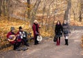 Autumnal view of Sofiivka park with girls and musicians.